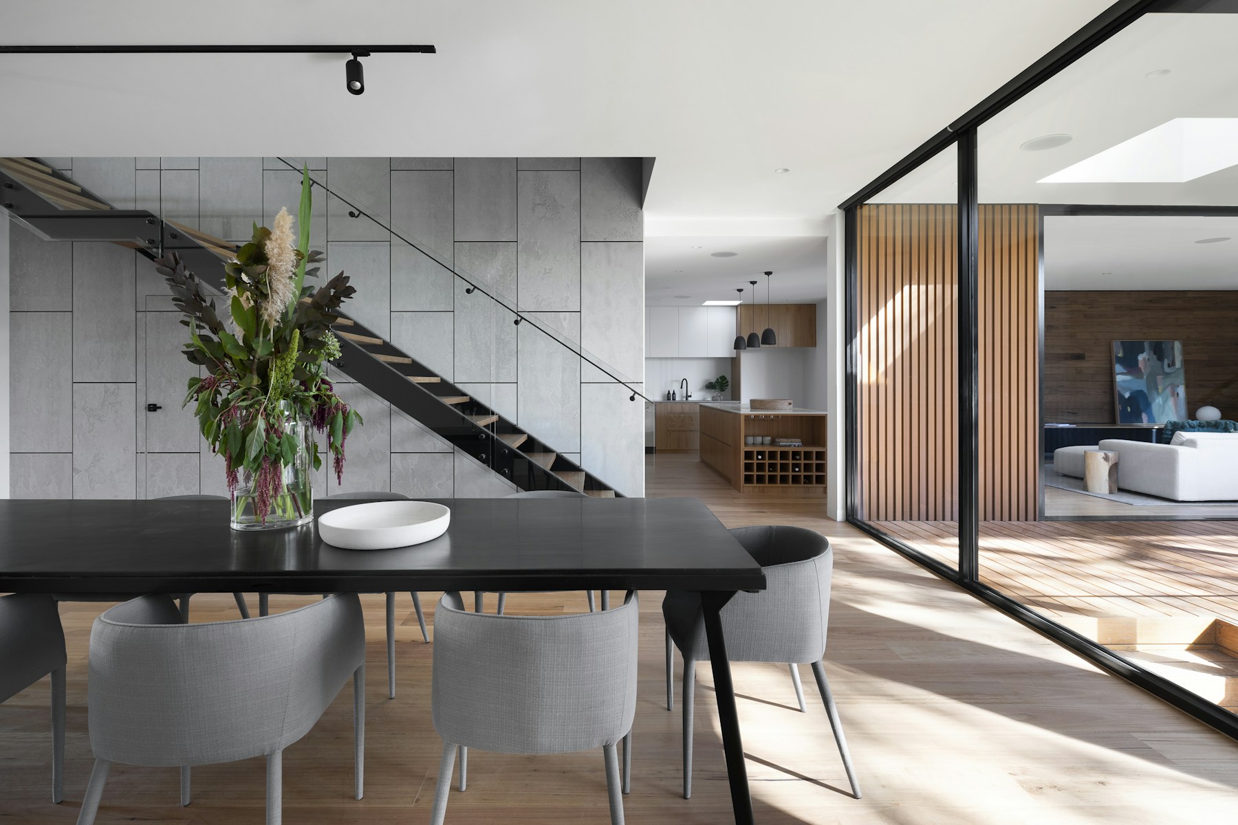 Airy contemporary interior with restrained furniture and warm finishes