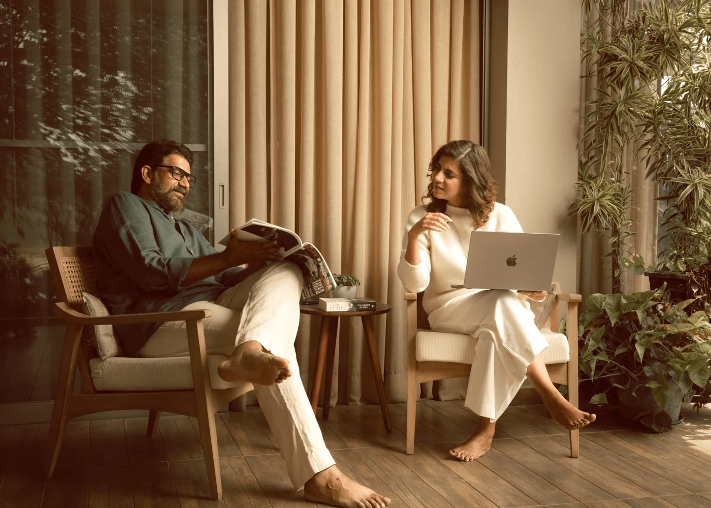 Two people relaxing on a planted terrace at Zion Hills
